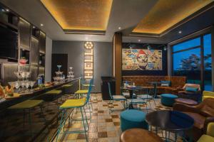 a restaurant with chairs and tables and a bar at Fairfield by Marriott Sriperumbudur in Sriperumbudur