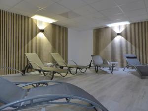 a waiting room with chairs and lights on the wall at Winterberg Citylife Wifi, PS4, Netflix ,Pool, Sauna, near Bikepark in Winterberg