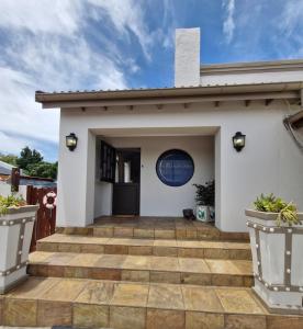 a white house with a large patio at A Time And A Place in Plettenberg Bay