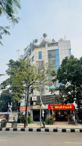a tall building with a store in front of it at Hotel Golden Inn Dhaka in Dhaka