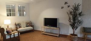a living room with a flat screen tv on a table at Ca La Silvia Masboquera in Mas Boquera