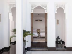 a hallway of a house with white columns at Raffles Al Areen Palace Bahrain in Manama