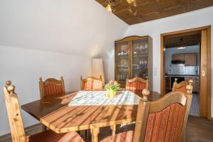 een eetkamer met een houten tafel en stoelen bij Ferienwohnung Frechehof 136 qm in Bad Peterstal-Griesbach