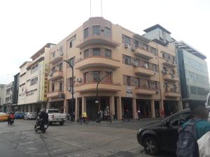 a large building on a city street with cars at Hotel City Central Guayaquil in Guayaquil