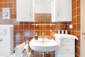 a bathroom with a sink and a toilet at Haus Erna am Deister in Barsinghausen +17 photos