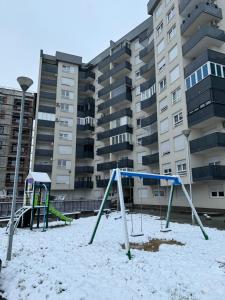 an empty playground in front of a building at Amina in Tuzla