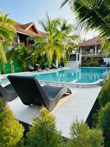 a resort with a swimming pool with chairs and trees at Family House Resort, Haad Rin in Haad Rin +59 photos