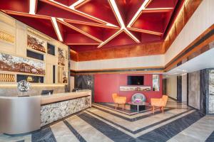 a lobby with a red ceiling and orange chairs at Best Western Click Sathorn 11 Bangkok in Bangkok