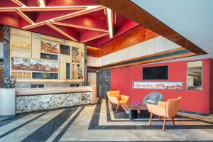 a lobby with red walls and orange chairs at Best Western Click Sathorn 11 Bangkok in Bangkok