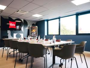 ibis Rouen Centre Rive Droite Pasteur في رووين: غرفة طعام مع طاولة وكراسي