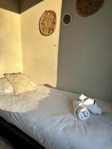 a white bed with two stuffed animals on it at Stads charme & comfort Tilburg in Tilburg