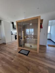 a room with a large glass window on a wooden floor at Apartment Nia mit Sauna und Whirlpool in Euskirchen