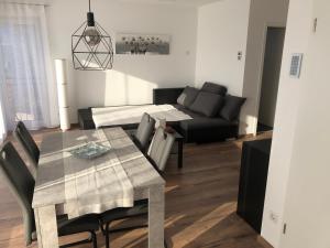 a living room with a table and a couch at Fewo Rhein-Lahn Penthouse OG3-1 in Lahnstein