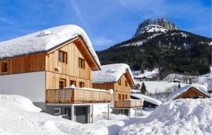 a house covered in snow with a mountain in the background at Nice Home In Ebensee With Ethernet Internet in Ebensee