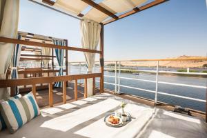 a table on a balcony with a view of the water at M/Y ALYSSA - 4 or 7 Nights From Luxor each Monday and 3 or 7 Nights From Aswan each Friday in Luxor