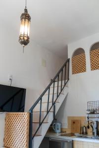 a kitchen with a staircase and a kitchen with a sink at Azafran Jerez apartamentos in Jerez de la Frontera