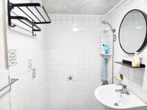 a white bathroom with a sink and a mirror at Stay in North Seoul in Seoul