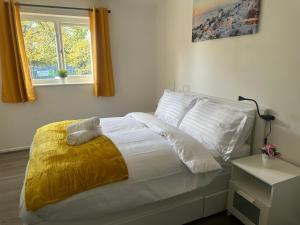 1 dormitorio con 1 cama con sábanas blancas y ventana en The Rodher house en Mánchester
