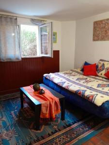 a bedroom with a bed and a table and a window at L'Auberge du Périgord in Truffe +29 photos