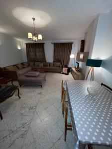 Villa le bon coin de la marsa في المرسى: غرفة معيشة مع أريكة وطاولة