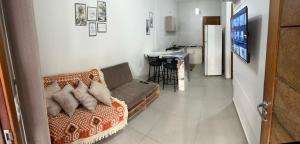 a living room with a couch and a kitchen at Casa Itajuba, Barra Velha, 20km do Beto Carrero in Barra Velha