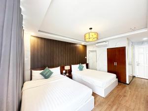 Postel nebo postele na pokoji v ubytování ACE Hotel - Bến Thành