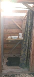 a room with a shelf with a plate and a cup at L'échappée au jardin, yourte bucolique in Godinne