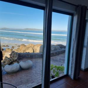 a view of the ocean from a window at Raaswater Self Catering in Langebaan