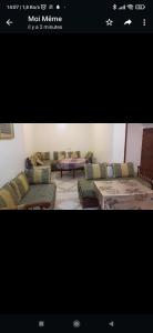 a picture of a living room with couches and tables at Appartement meublé in Meknès