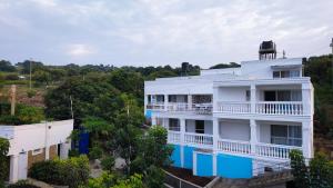 an aerial view of a white building with blue accents at TAKAWIRI VICTORIA SANDS in Takawiri Island