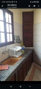 a kitchen counter with a sink and a window at Appartement meublé in Meknès