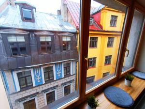 a view of a building from a window at Elegant Old Town Toffee Bliss Apartment, SELF Check-In, Steps from Bus Station in Riga