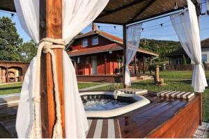 a patio with a hot tub in the backyard of a house at Family House Maksimović in Valjevo