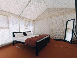 a bedroom with a bed in a tent at Rann Heritage Resort in Dhordo
