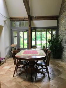 a dining room with a table and chairs at Cozy Somerset country cottage in Somerton