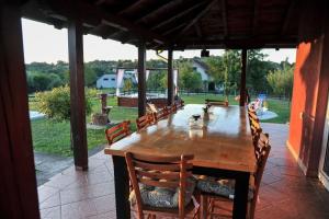 een houten tafel en stoelen op een patio bij Family House Maksimović in Valjevo