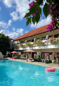 a swimming pool in front of a hotel at Marine Bay Sanur in Sanur