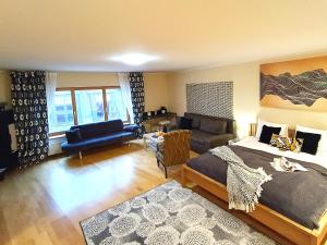 a bedroom with a bed and a living room at Elegant Old Town Toffee Bliss Apartment, SELF Check-In, Steps from Bus Station in Riga