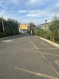 an empty road with a building in the distance at Beteyà Hostel Don Bosco in Catania