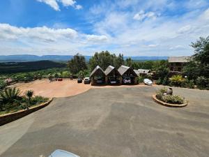 a large parking lot with a group of huts at Sable Mountain in Hekpoort +17 photos