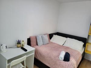Habitación pequeña con cama y escritorio. en comfy guest Apartment, en Varsovia