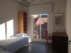 a bedroom with a bed and a view of a balcony at Beautiful & Bright Apartment Near Ramblas in Barcelona