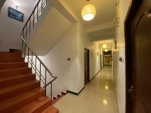 a hallway of a building with stairs and a light at La Paradise Residency in Puducherry