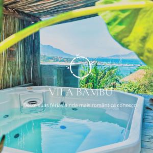 a bath tub with a view of the ocean at Vila Bambu Ilhabela, Santa Tereza in Ilhabela