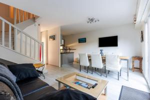 a living room with a couch and a table at Cap-ferret Phare Réf 130 in Lège-Cap-Ferret