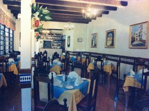 a restaurant with tables and chairs with blue table cloth at Hotel Iberia - San Juan in San Juan