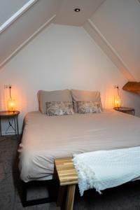 a bedroom with a large bed with two pillows at Boldiek - Genieten van rust en ruimte in de Achterhoek in Halle