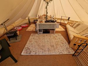 a living room with a tent with a couch and a table at Beautiful 1-Bed bell tent in Holyhead in Holyhead