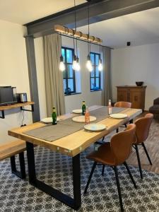 a dining room with a wooden table and chairs at Eifel-Bau-Traum Schlich in Wershofen