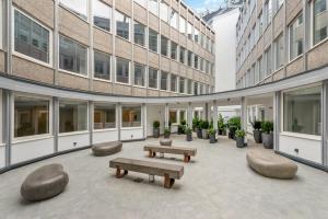 a courtyard of a building with benches and plants at Stunning 1 Bed Studio Flat With FREE PARKING and FREE WIFI in Capella Court Purley in Purley
